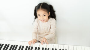Smiling girl playing the piano